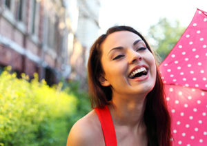 Young woman smiling after Invisalign treatment