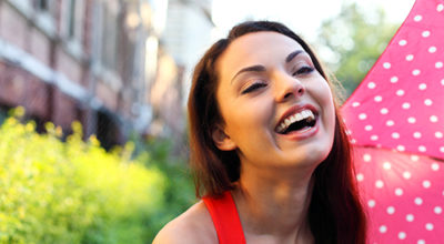 Young woman smiling after Invisalign treatment