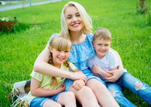 Teen and young children smiling after braces.