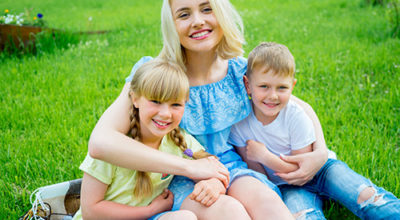 Teen and young children smiling after braces.