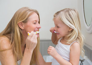 Mother Teaching Daughter to Brush Teeth | GSO