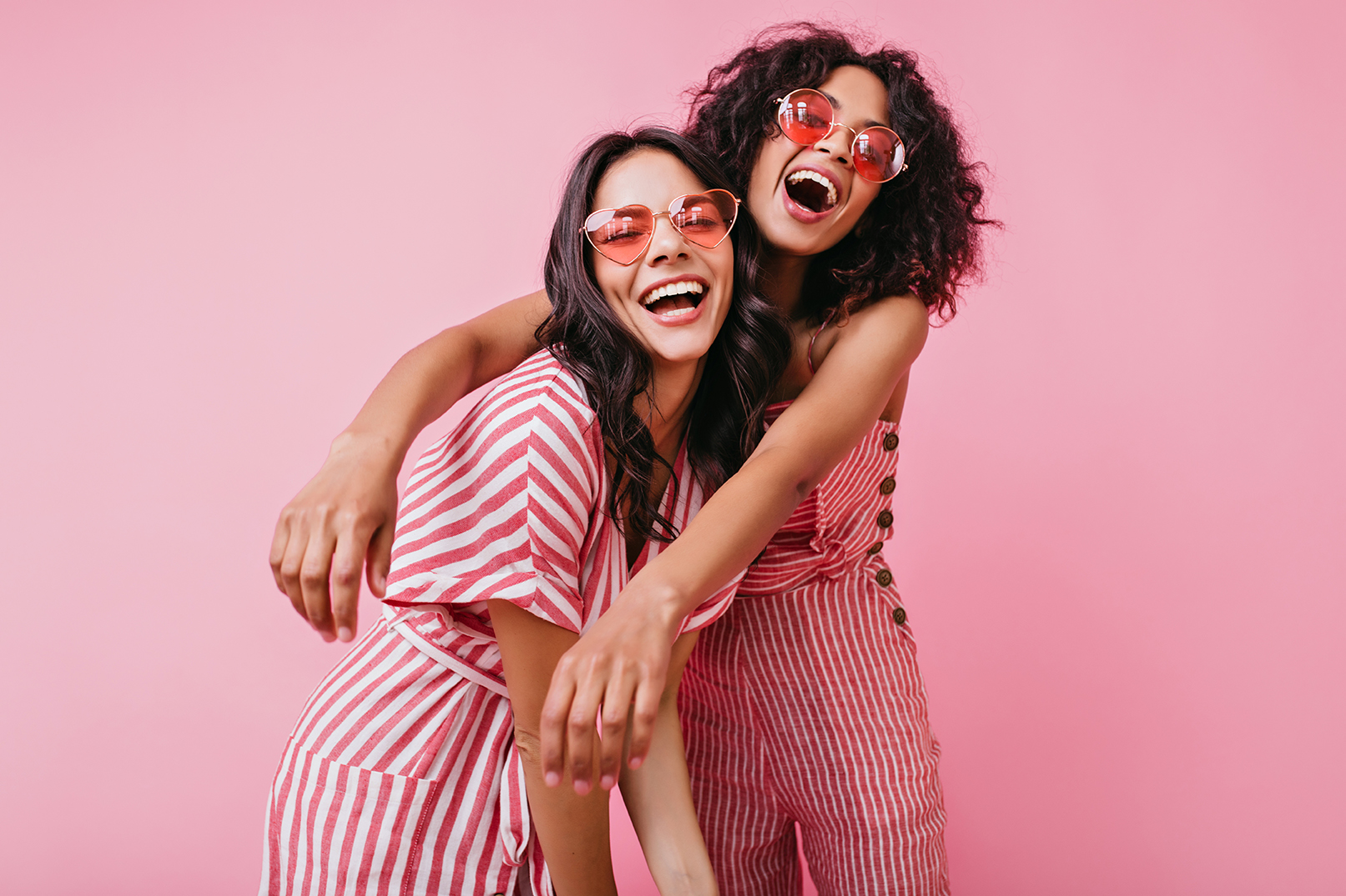 Happy friends with light dresses posing