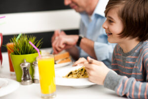 Boy eating pasta with braces
