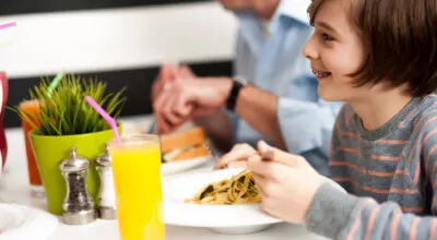 Boy eating pasta with braces
