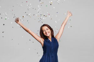 Beautiful happy women celebrating as confetti falls
