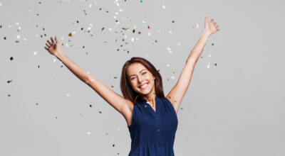 Beautiful happy women celebrating as confetti falls